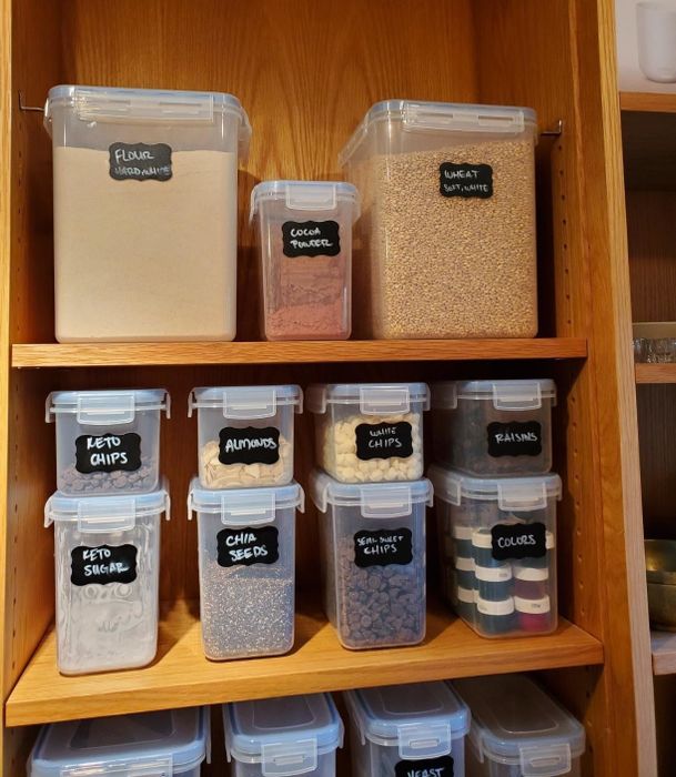 A reviewer’s image showing the complete 15-piece Vtopmart Airtight Food Storage Containers Set neatly organized in a cabinet, used for storing various types of food