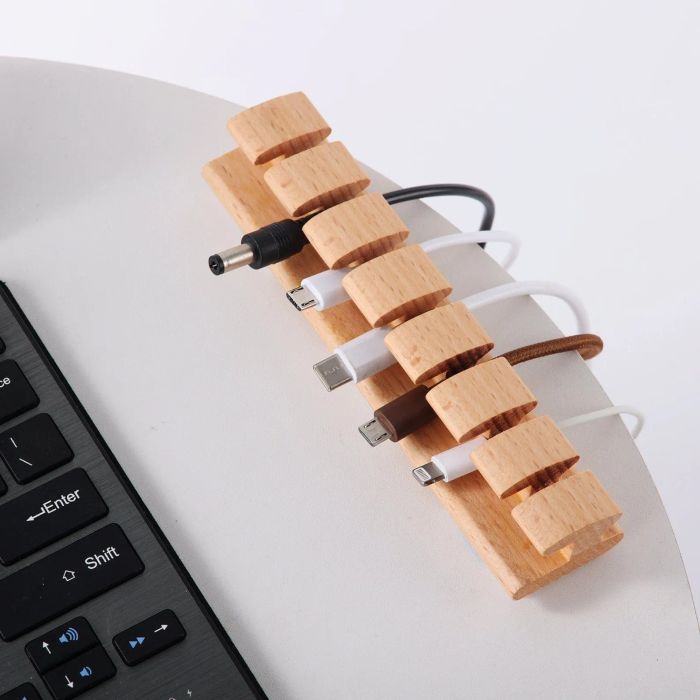 The light wood cord organizer neatly holds various cords in place.