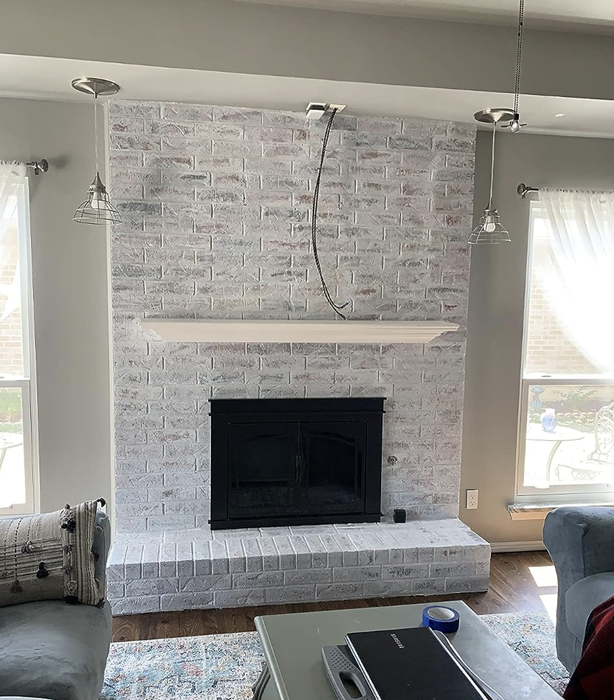 Same reviewer's fireplace after using the whitewash kit, now a fresh white hue.