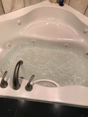 A tub running with clean, clear water.