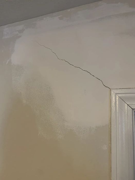 A reviewer photo showing a wall with a large crack