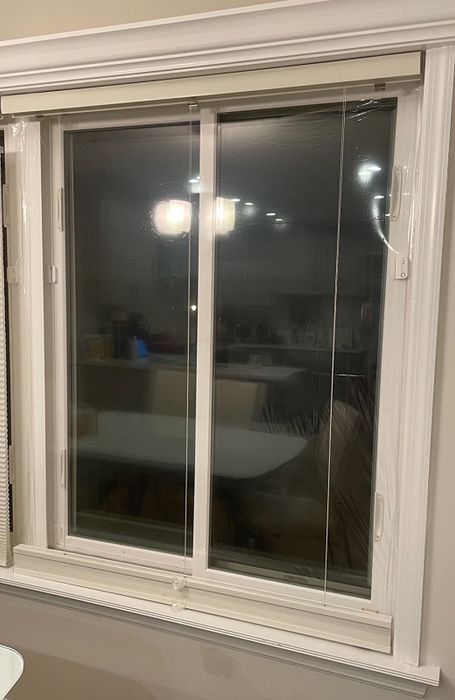 A reviewer's photo showing their window with the film securely attached