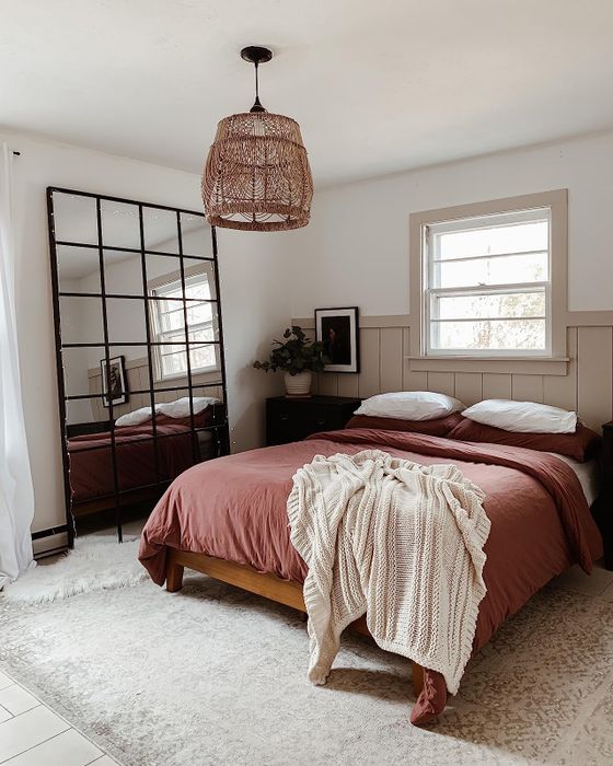 A reviewer’s cozy bed adorned with a rich burnt orange duvet set.