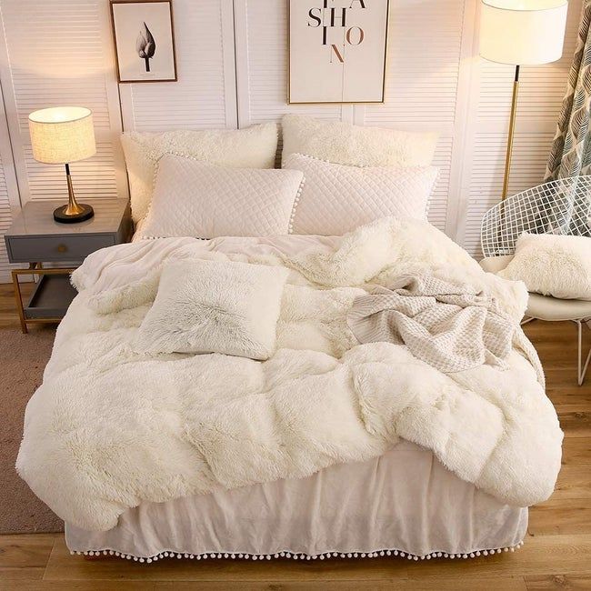 A white shaggy faux-fur duvet cover on a bed