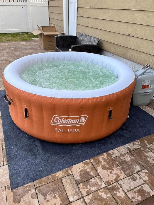 A Coleman SaluSpa inflatable hot tub set up on a patio