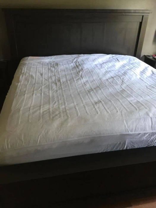 A freshly made bed topped with a heated mattress pad for ultimate warmth and comfort