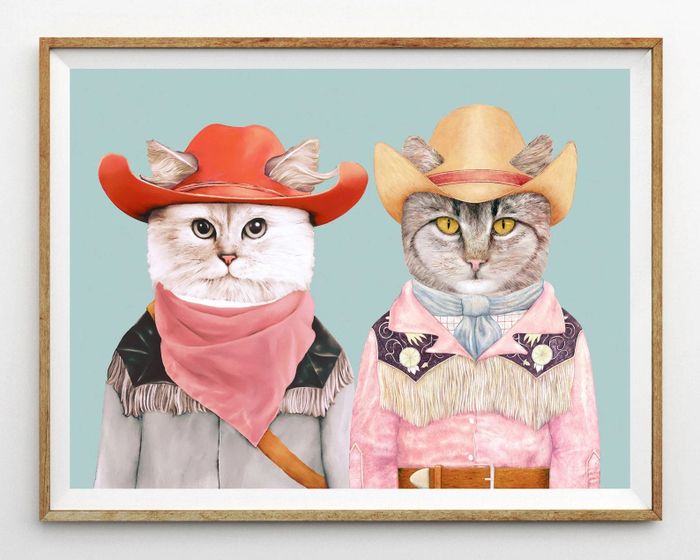A print featuring two cats dressed in cowboy outfits