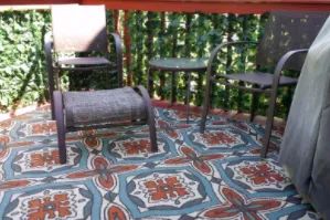 A reviewer's photo of a deck with faux ivy wrapped around the railing to obscure the view below