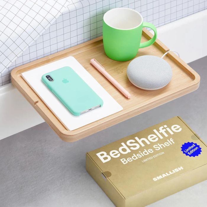 A floating bedside shelf positioned beside a bed