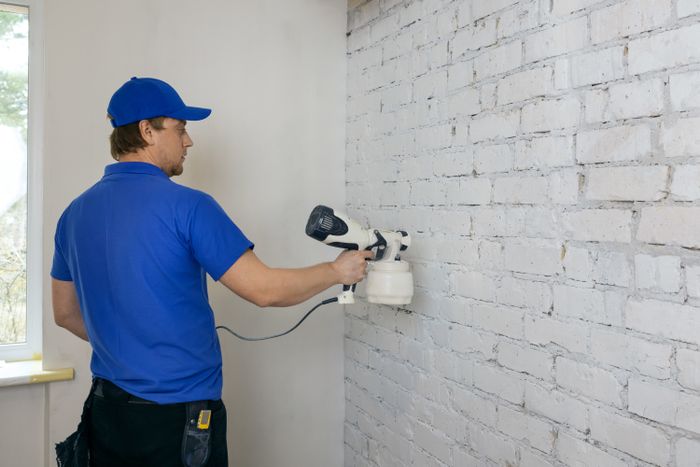 Coating a brick wall with white paint