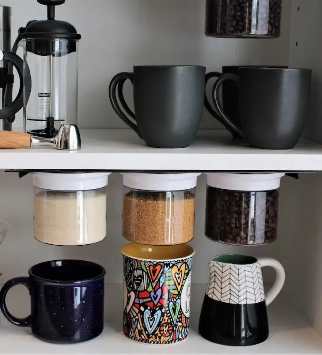 Three canisters being used to store floss, cotton balls, and swabs