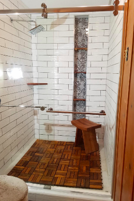 A reviewer’s shower floor featuring the interlocking teak tiles