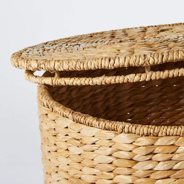 A close-up shot of a woven wicker basket with a matching lid, perfect for stylish storage. This item falls under the Shopping category.