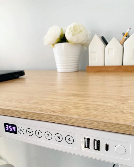 A close-up of the reviewer's desk shows the controls and USB ports for easy access.