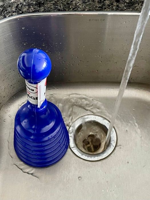 A small blue sink plunger.