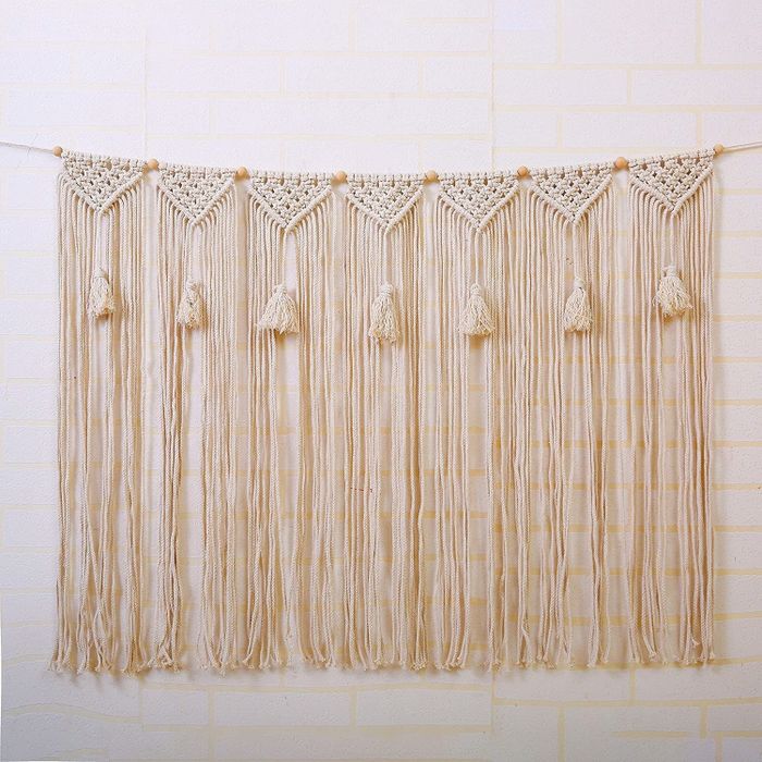 A natural rope macrame wall hanging featuring tassels for a boho-chic look.