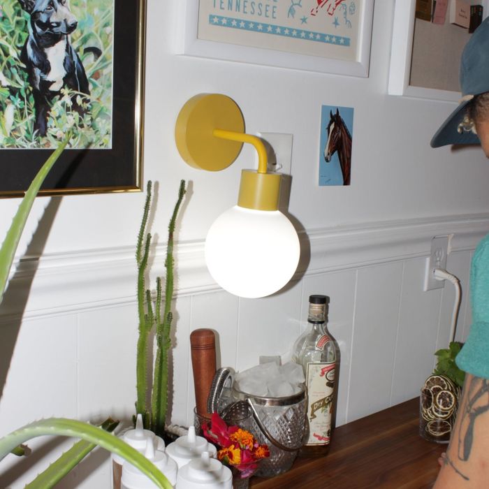 The marigold yellow poplight mounted on a white wall.