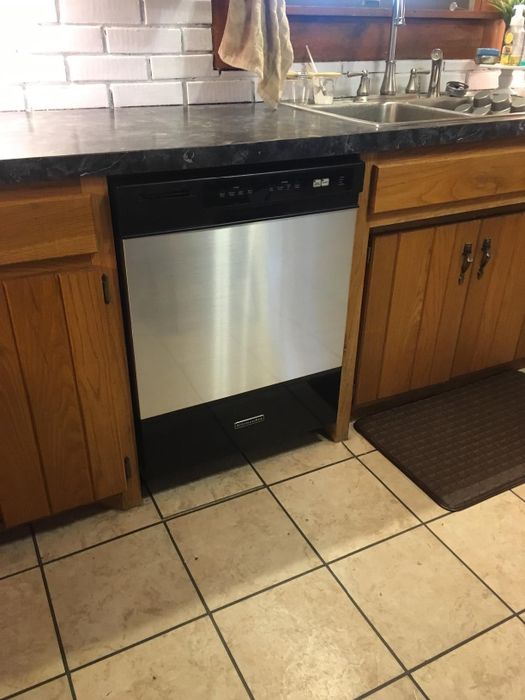 A reviewer's dishwasher covered with sleek stainless steel contact paper.