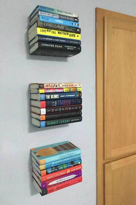 reviewer's photo of three stacks of floating bookshelves