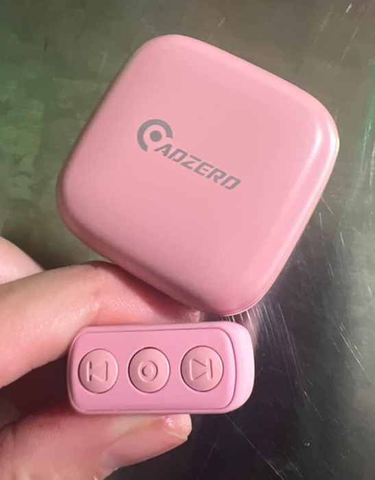 A reviewer holding the pink version of the TikTok remote control ring.