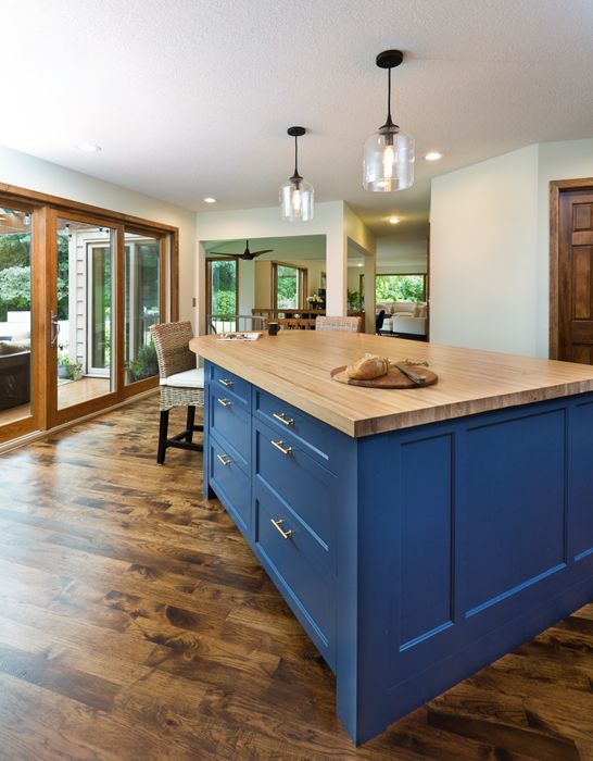 Blue kitchen cabinets paired with gold hardware