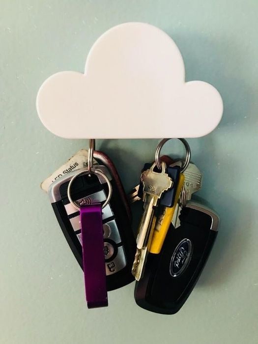 Two sets of keys hanging from the magnetic key holder