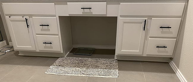 Bathroom cabinets featuring stylish new matte-black pulls, adding a contemporary touch to the space.