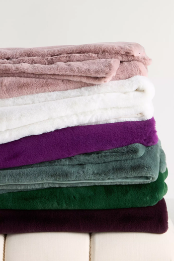 A pile of soft, plush blankets stacked together