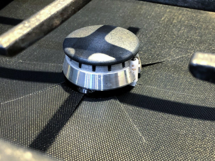 A reviewer’s picture of a burner cover that blends in seamlessly.