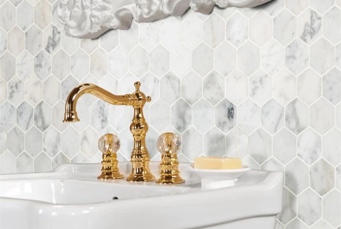 A striking honeycomb tile design used as an elegant backsplash behind a modern sink.