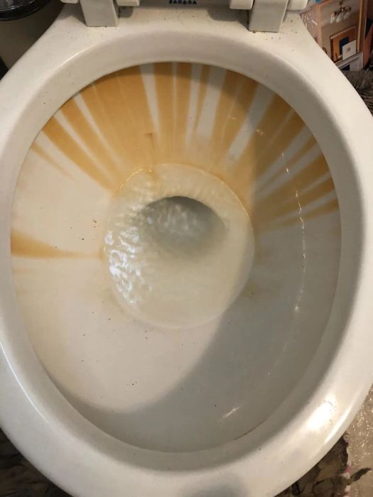 toilet bowl stained with rusty marks