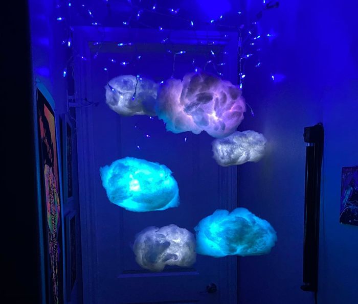 The cloud-shaped lights suspended in varying shades of blue