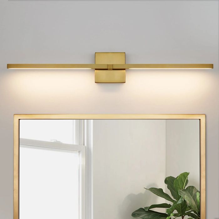 Sleek wall-mounted light fixture positioned above a mirror, casting a warm, inviting glow—ideal for modern bathroom vanity lighting.