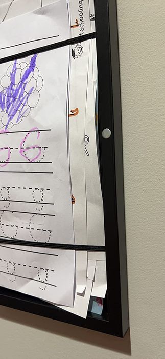 A reviewer's open frame displaying multiple pieces of artwork inside.