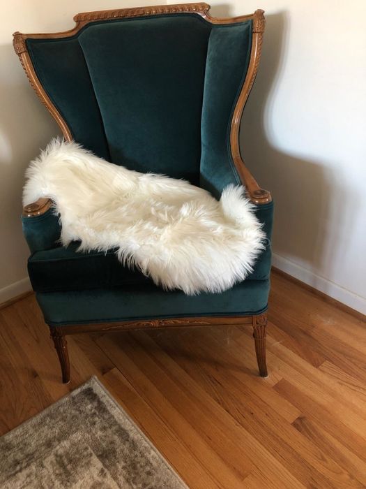 The reviewer's chair draped with a soft white faux-fur rug for a cozy, chic look.