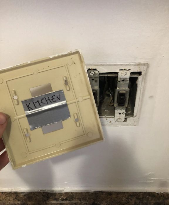 old mismatched switchplate being taken off the wall