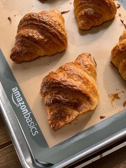 A reviewer's croissants baking on a sheet pan.