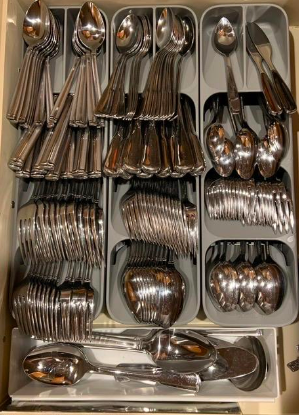Multiple utensil organizers placed side by side, with various utensils neatly sorted into their individual slots