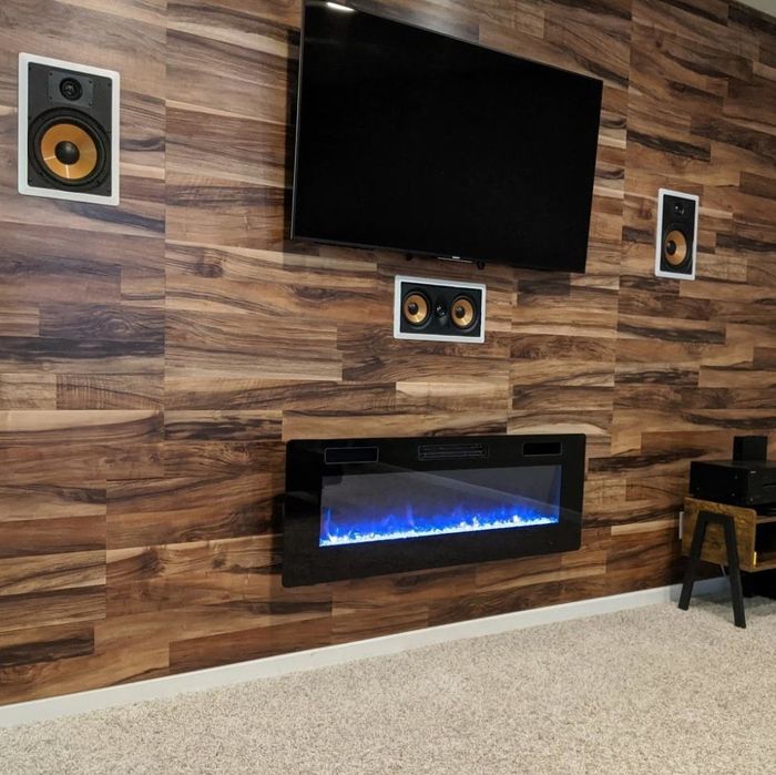 A reviewer's electric fireplace mounted beneath a TV