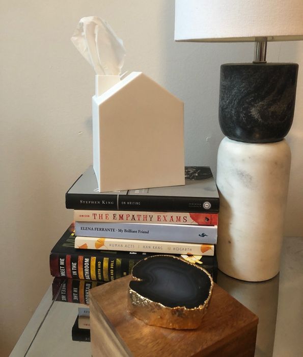 The tissue box covers resting atop a stack of books