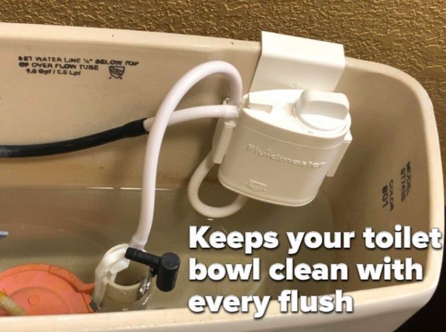 A reviewer's image showing the system installed, clipped to the tank and connected to two of the toilet's internal tubes
