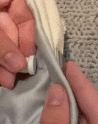 A model demonstrating how to use the magnetic key to unpin a duvet.