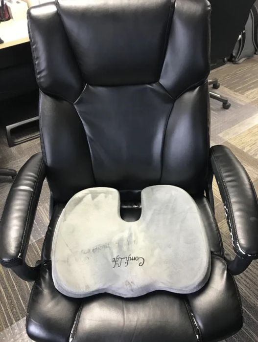 A reviewer's photo showing the velvet-like cushion on the seat of an office chair.