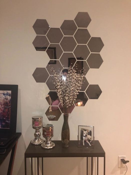 A reviewer's set of hexagon-shaped mirrors on display on the wall