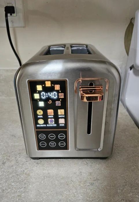 A sleek, modern toaster with digital controls on a kitchen counter, featuring settings for different types of bread.