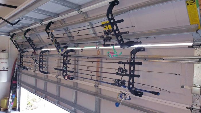 inside view of a garage door with racks holding fishing poles horizontally, without interfering with the garage door's use