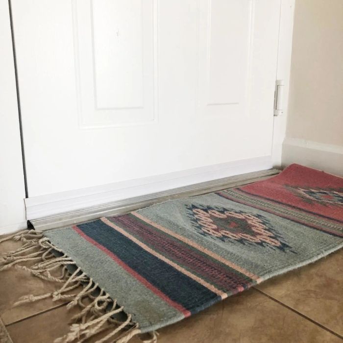 reviewer's photo of a white door with a barely noticeable door draft stopper at the bottom