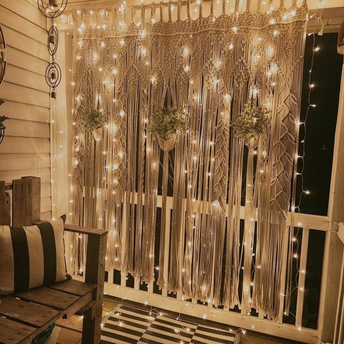 A reviewer’s macramé curtain with fairy lights intertwined, creating a charming glow.