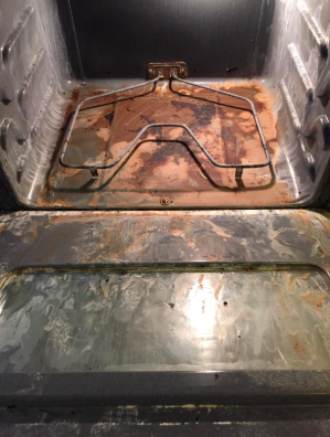 A filthy, baked-on mess inside an oven.