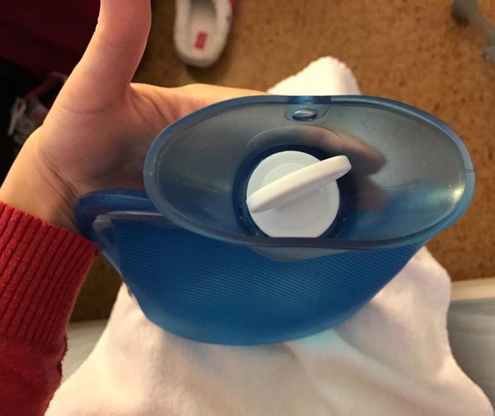 A top-down view of the hot water bottle, featuring the white stopper lid